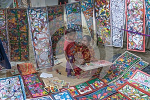 Colourful handicrafts are being prepared for sale in Pingla village by Indian rural woman mother worker.