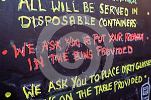 Colourful handwritten rules and information on a chalkboard at a pub that recently reopened with the easing of the coronavirus
