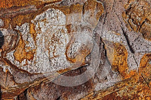 A colourful, harsh, stone background of a rock cliff