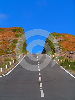 The colourful hill deeply cut by the road. Madeira photo