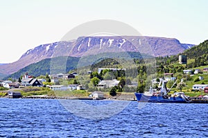 Colourful homes along Bonne Bay with The Tablelands on the horizon