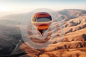 Colourful hot air balloon floating over distant fields and meadows on sunset. Generative AI