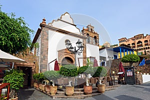 Colourful houses and palm trees on street in Adejec town, Tenerife, Canary Islands, Spain