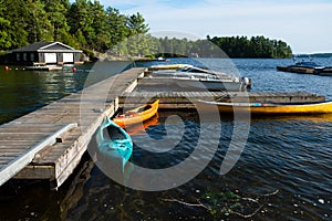 Colourful kayaks and canoes parked at the dock.