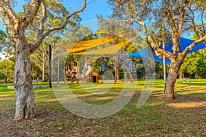 colourful Kids park with swings and slides yellow and blue shades in Suburban western Sydney