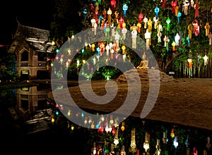 Colourful lanterns above Buddha statue.