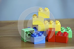 Colourful lego bricks on wooden background