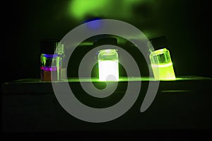 Colourful light induced catalyst photochemical reaction in glass vials under green light in a dark chemistry laboratory