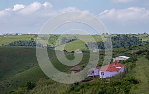 Colourful painted Zulu mud huts / rondavels in rural Kwazulu Natal, Wild Coast, South Africa