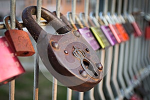 Colourful love padlocks shut to railing on Eiserner Steg bridge in Regensburg, Germany photo