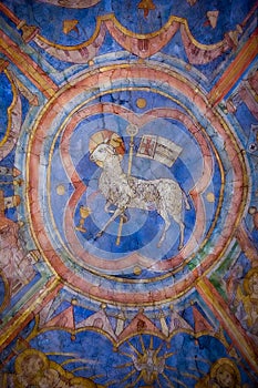 Colourful medieval painting on the ceiling of the main nave in Braunschweig Cathedral, with the peaceful sheep of Jesus in the