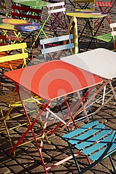 Colourful modern trendy tables and chairs at street cafe