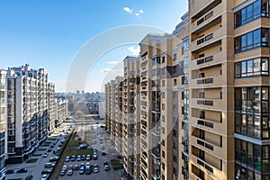 Colourful multi-storey complex of new buildings from balcony, Top view of beautiful multicolored design of facade of