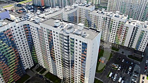 Colourful multi-storey complex of new buildings. Motion. Top view of beautiful multicolored design of facade of