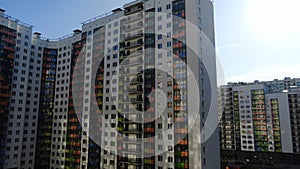 Colourful multi-storey complex of new buildings. Motion. Top view of beautiful multicolored design of facade of