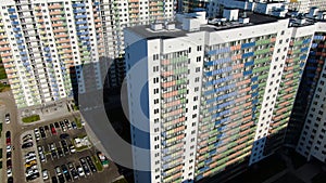 Colourful multi-storey complex of new buildings. Motion. Top view of beautiful multicolored design of facade of