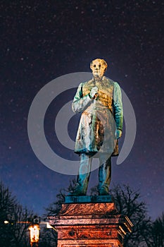 Colourful Night Starry Sky In Blue Colors. Close Up Of Statue Of Johan Ludvig Runeberg On Esplanadi Park In Lighting At