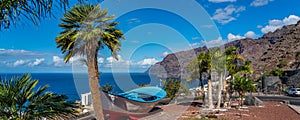 A colourful painted fishing boat on display near the ocean in Los Gigantes, Tenerife, Canary Islands,