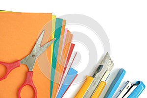 Colourful paper with office and school stationary on white