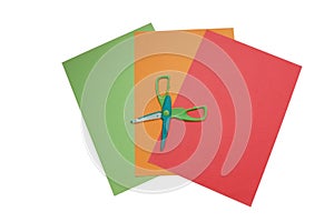 Colourful papers with open scissors