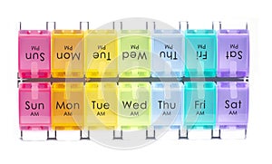 Colourful daily pill dispenser box on white background