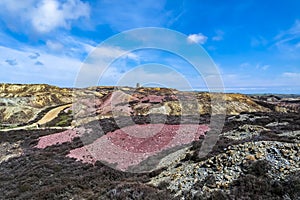 The colourful remains of the former copper mine Parys Mountain near Amlwch on the Isle of Anglesey, Wales, UK