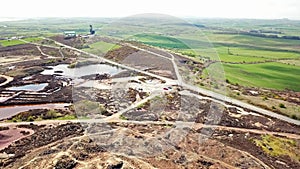 The colourful remains of the former copper mine Parys Mountain near Amlwch on the Isle of Anglesey, Wales, UK