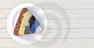 Colourful rice triangle shape in white ceremic dish on wood back photo