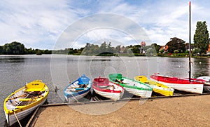 Colourful rowing boats on Thorpeness Mere, Suffolk photo