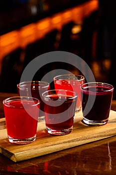 Colourful set of alcoholic cocktails in shot glasses shooters