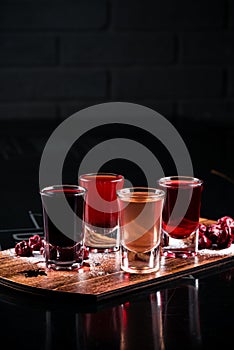 Colourful set of alcoholic cocktails in shot glasses shooters