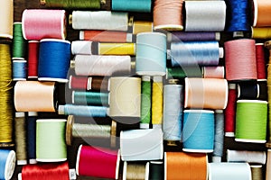 Colourful sewing threads background closeup