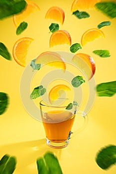 Colourful shot of orange fruit tea with orange slices and mint