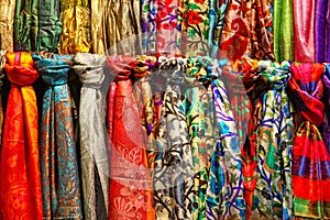 Colourful silk scarfs at a market stall photo