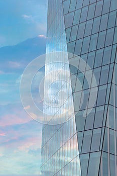 Colourful sky reflected in the exterior glass facade of a modern corporate building