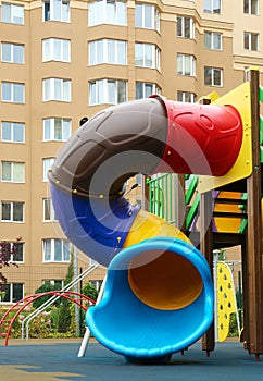 Colourful slide on outdoor playground for children in residential area