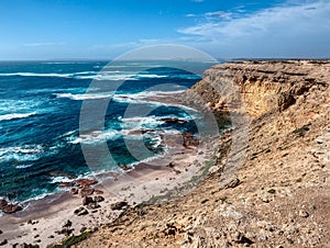 Colourful soft sea waves at rocky sea shore