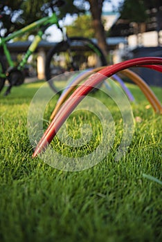 Colourful spiral bicycle racks available in a park. Seeing one bike on a rack.