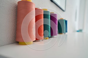 Colourful spools are standing in tailor office