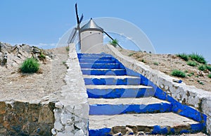 Colourful stairs lead to old windmill in Consuegra, Toledo, Spain.