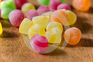 Colourful sugar sweets with licor inside on the wooden table background photo