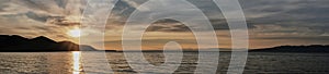 Colourful sundown on Barguzinsky Bay of Lake Baikal, Russia. Scenic clouds on sky.