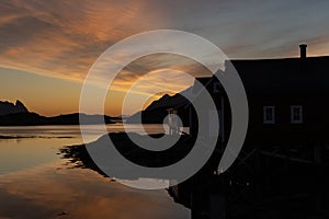 Colourful sunrise and morning light over Norwegian fisherman\'s hut in Lofoten, Norway