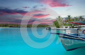 colourful sunset at the maldive island with a boat and boardwalk