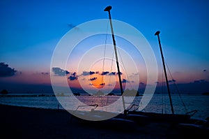 The colourful sunset of sailing boat on the Tropical Beach at Maldives