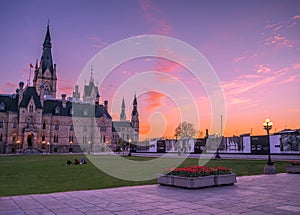 Colourful sunset sky over Parliament Hill, red tulips, Ottawa, Ontario, Canada photo