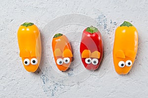 Colourful sweet mini peppers in the shape of mouses, stone table, snack for kids idea