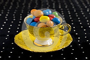 Colourful sweets in vintage teacup