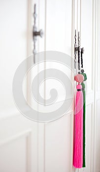 Colourful tassels with White cabinet.