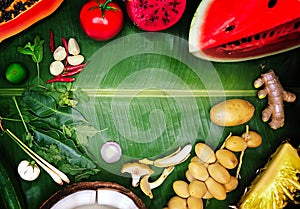 colourful Thai herb vegetable and fruits for Thai food ingredient cooking on green banana leaf background